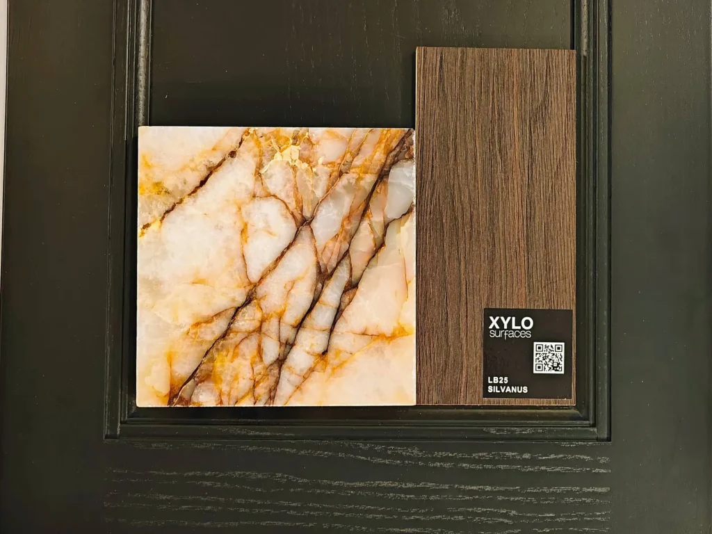 Natural stone worktop sample and Xylo Silvanus woodgrain panel on a black in-frame cabinet door