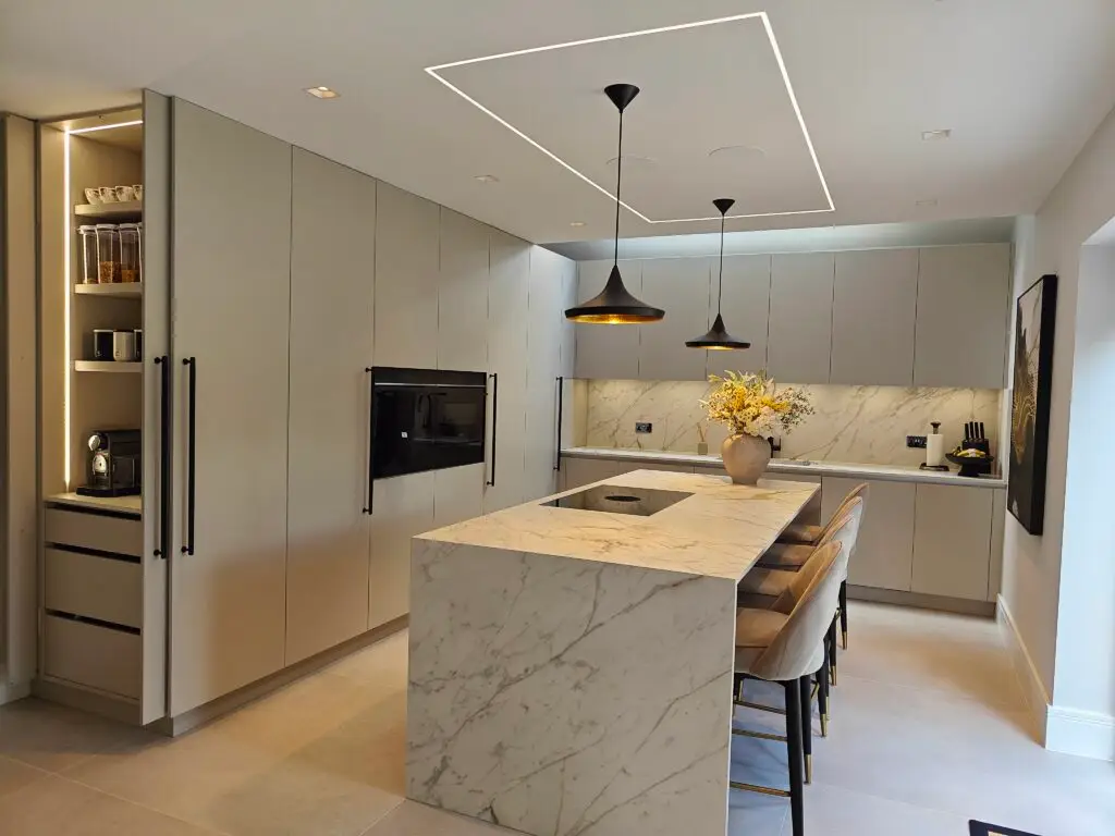Contemporary Sevenoaks kitchen with Egger Taupe Grey cabinetry and Soft Black PerfectMatt island, Marazzi porcelain worktops and a flush-fitted BORA X Pure vented hob, by Kraus Kitchens